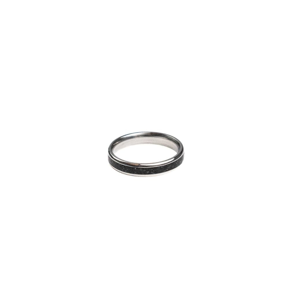 4mm stainless steel ring with black stone and brass shavings inlay.