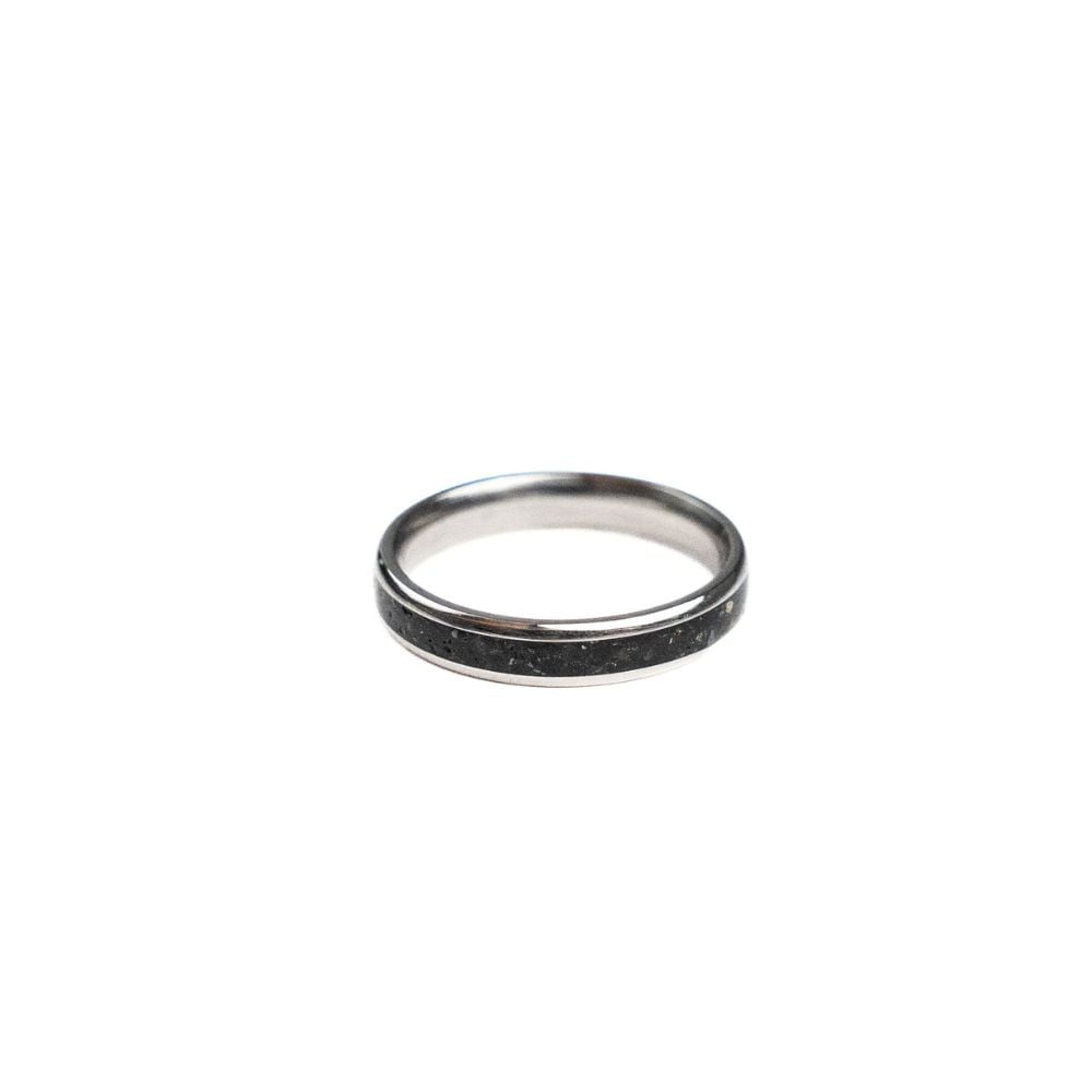 4mm stainless steel ring with black stone and brass shavings inlay.