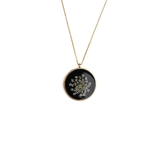 Gold round pendant necklace with real wild lace flowers from Germany set in resin on a gold plated sterling silver chain.