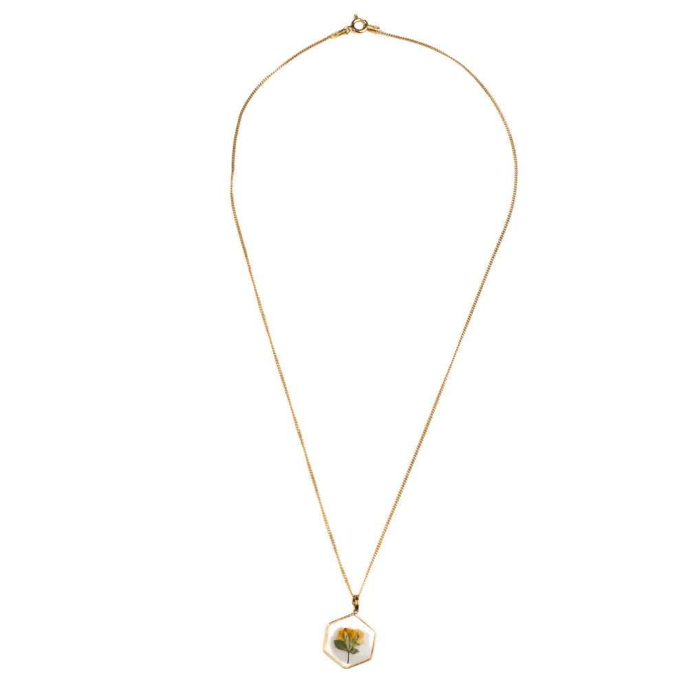 Hexagon gold plated necklace with real wild pea flower preserved in resin.
