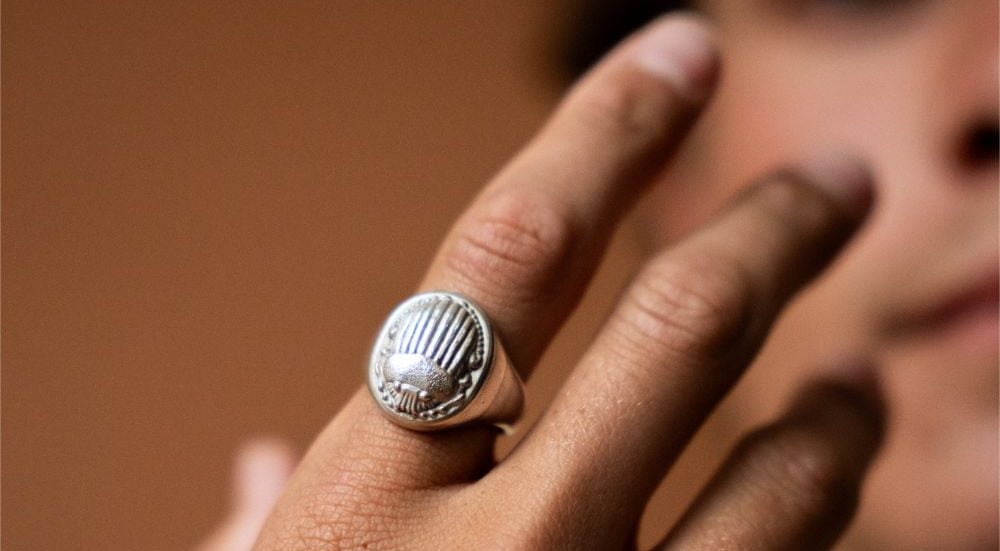 Sterling silver signet ring with engraved scarab design.