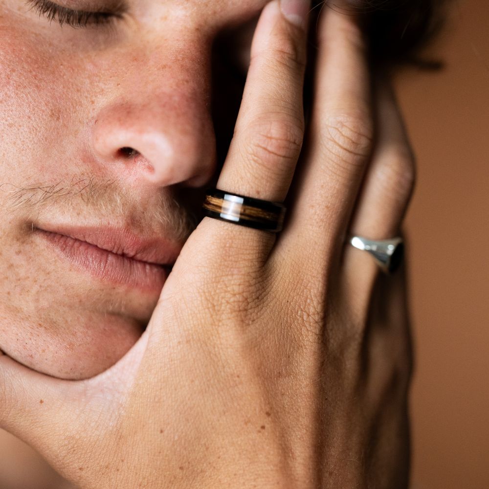 Black ceramic 8mm ring with Zebrano wood inlay featuring natural striped grain.