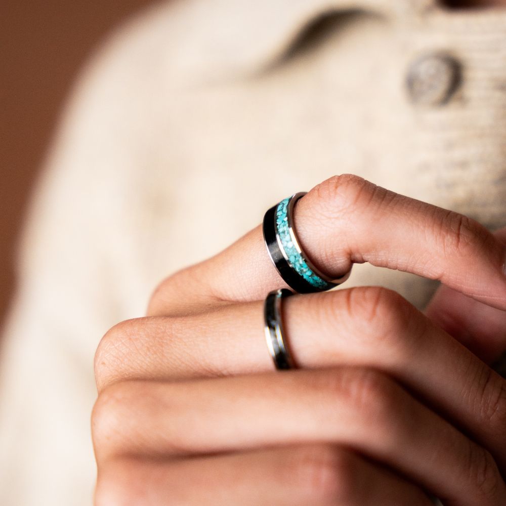 Stainless steel ring with turquoise stone inlay and black stone accent band.