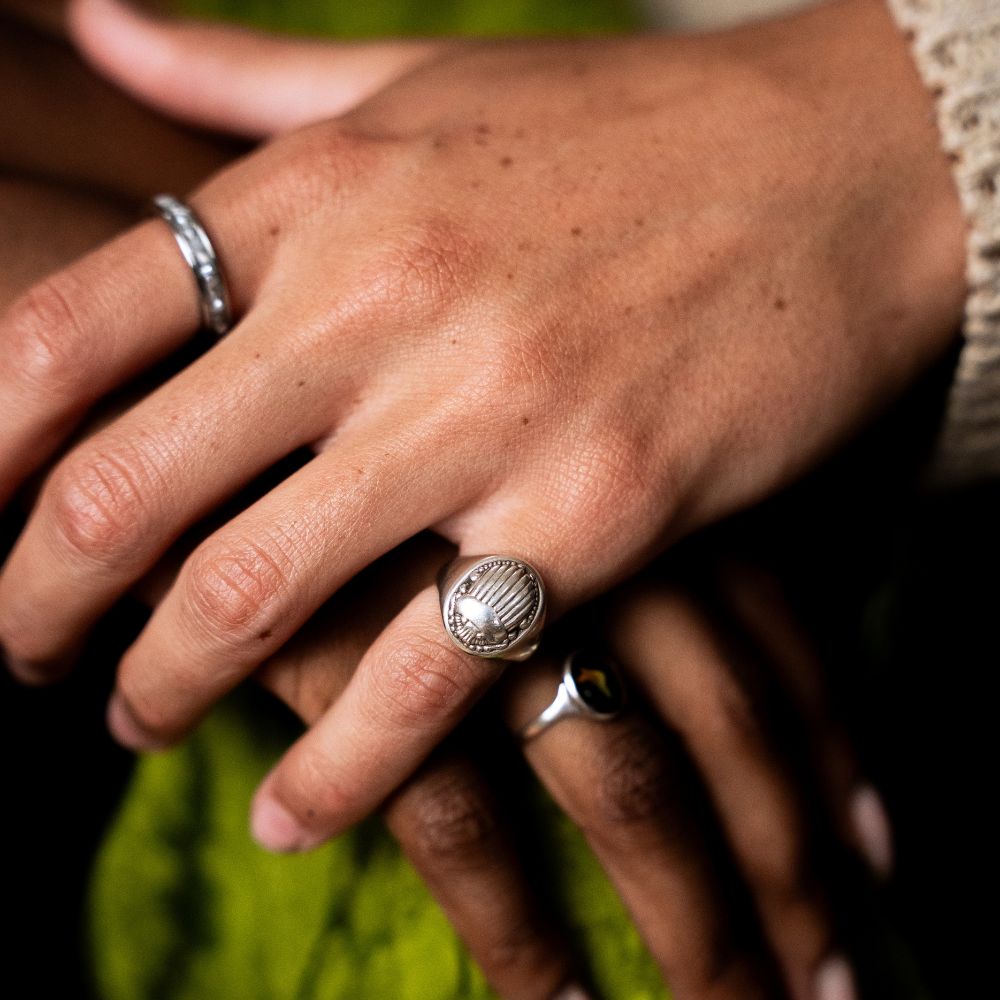 Sterling silver signet ring with engraved scarab design.