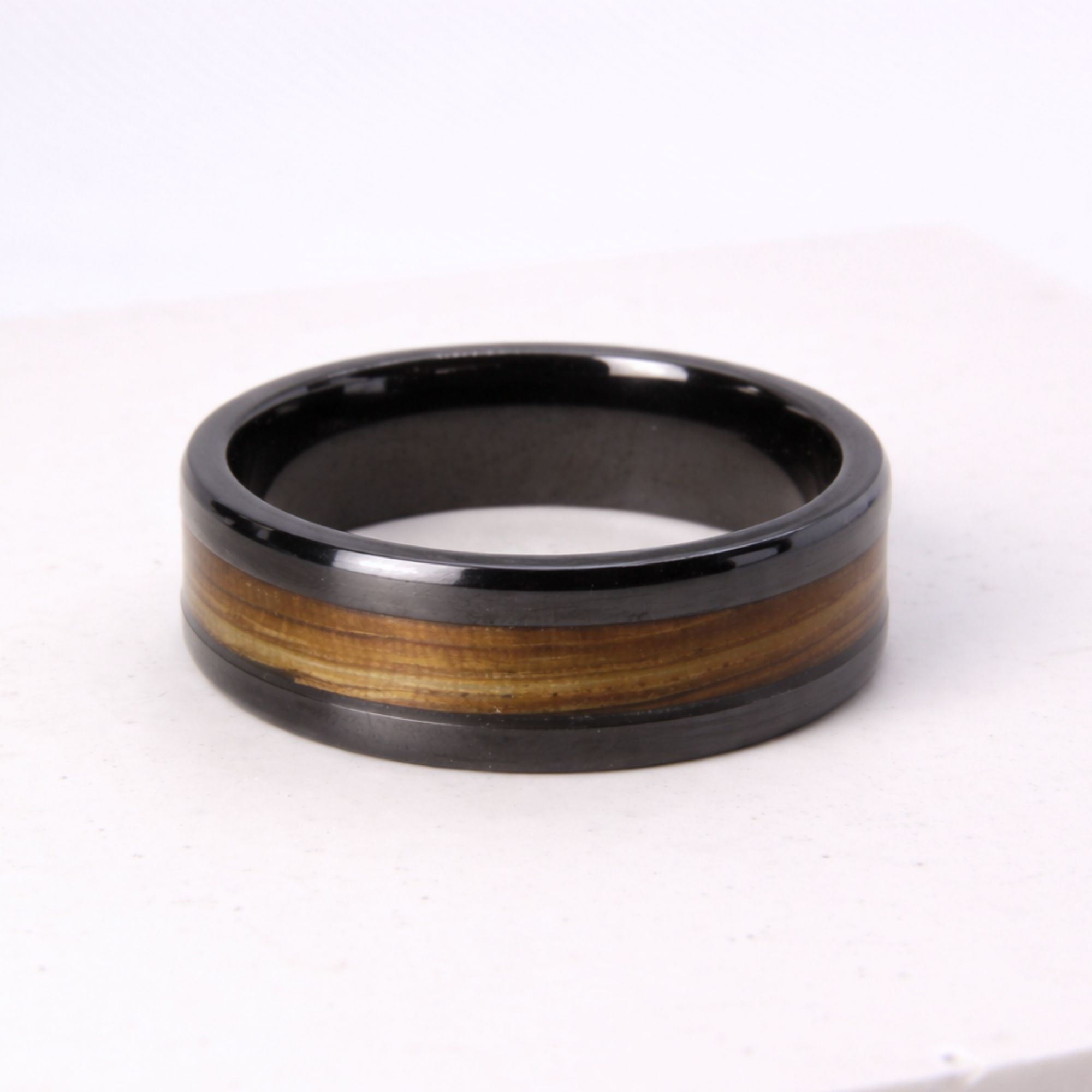 Black zirconium ring with zebrano wood inlay.