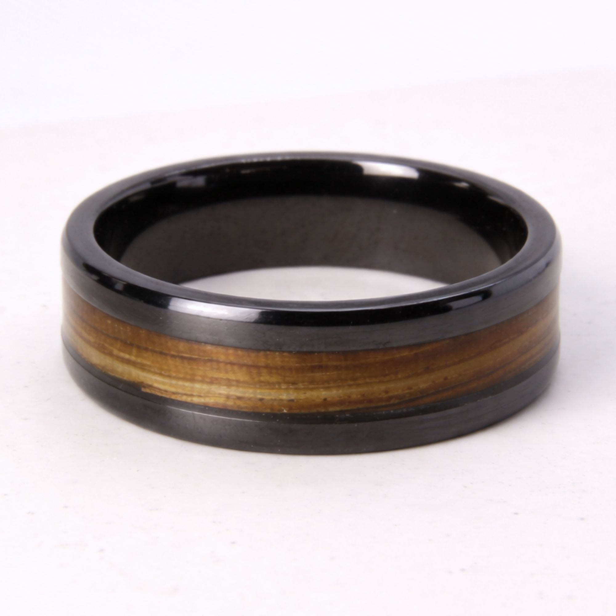 Black zirconium ring with zebrano wood inlay.