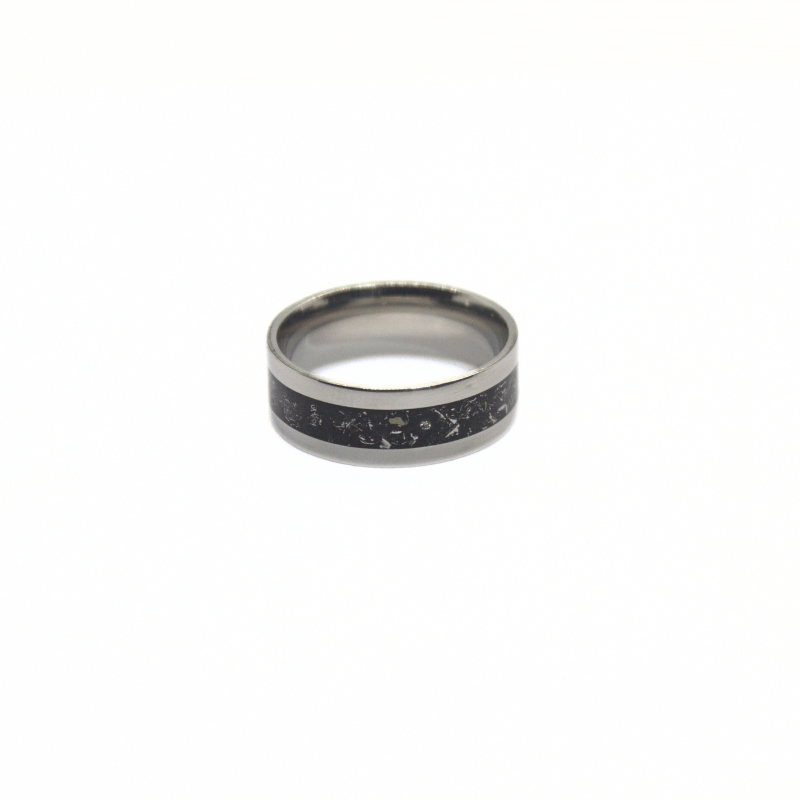 Stainless steel ring with black inlay featuring meteorite shavings from Campo del Cielo.