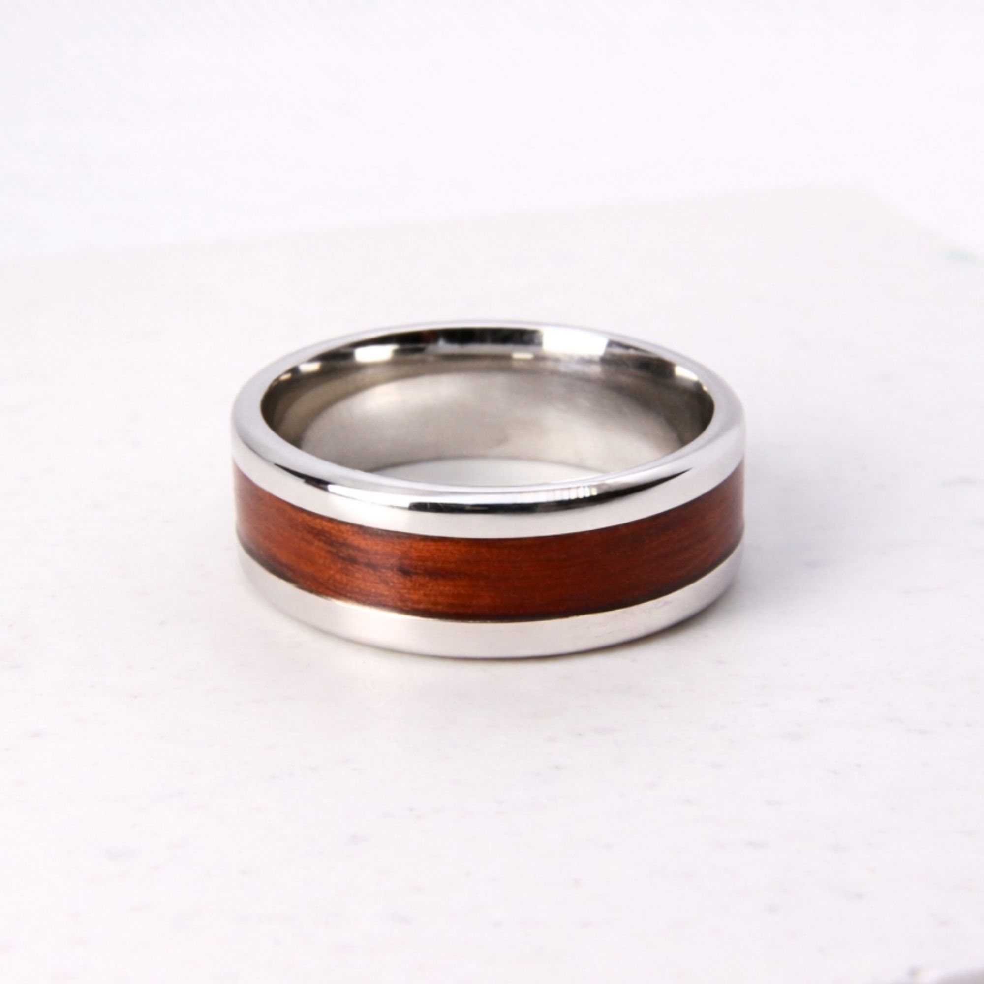 Stainless steel ring with rosewood inlay.