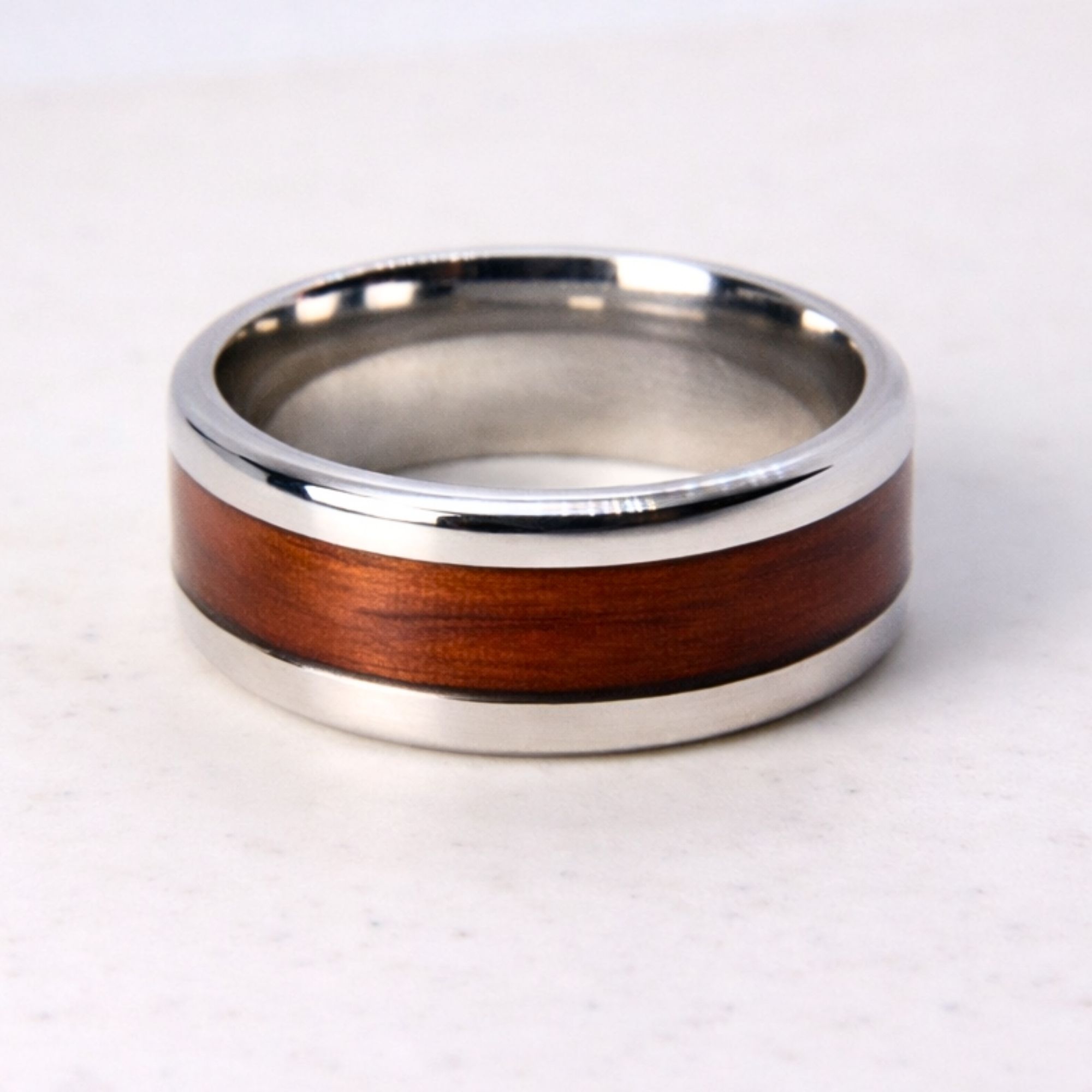 Stainless steel ring with rosewood inlay.
