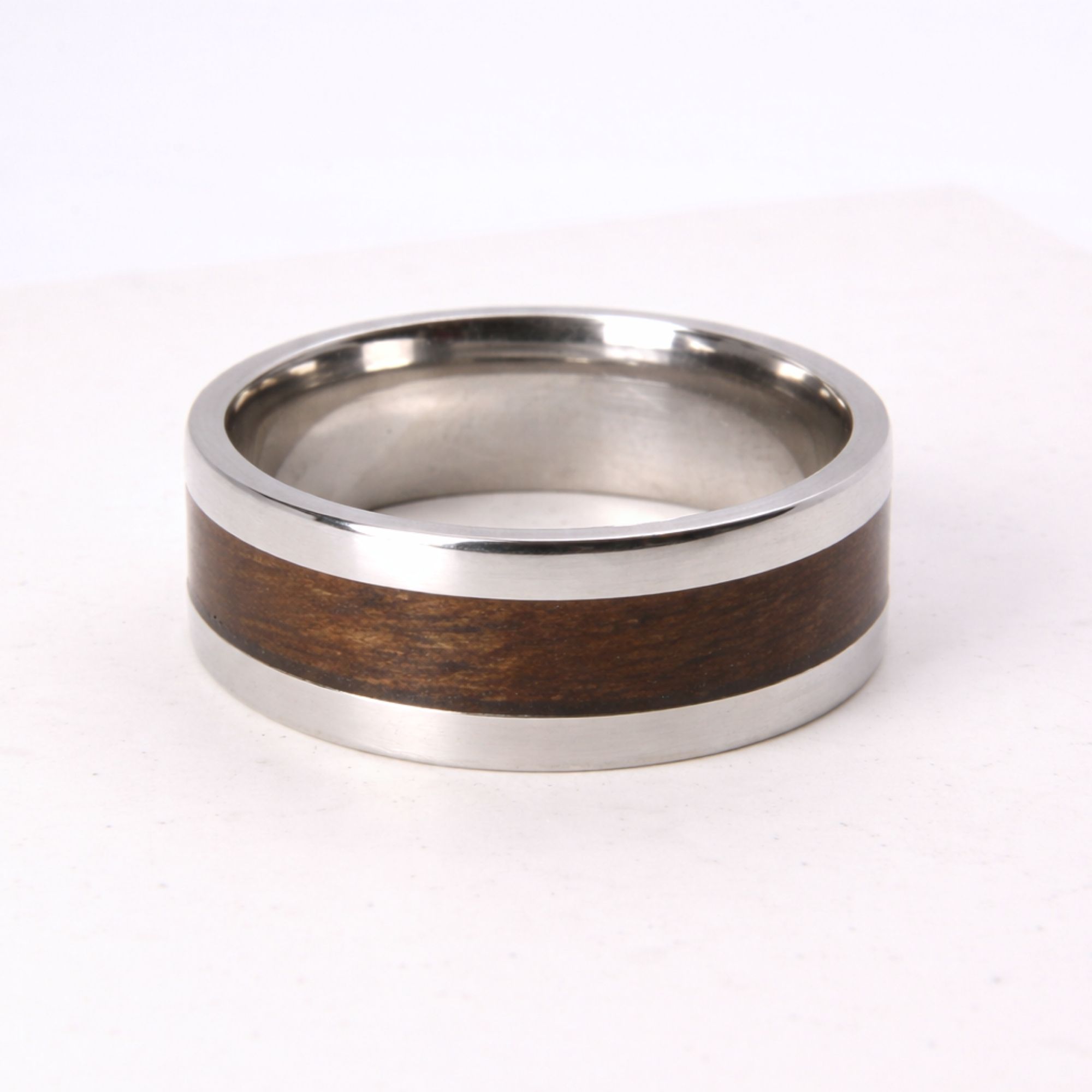 Stainless steel ring with walnut wood inlay.